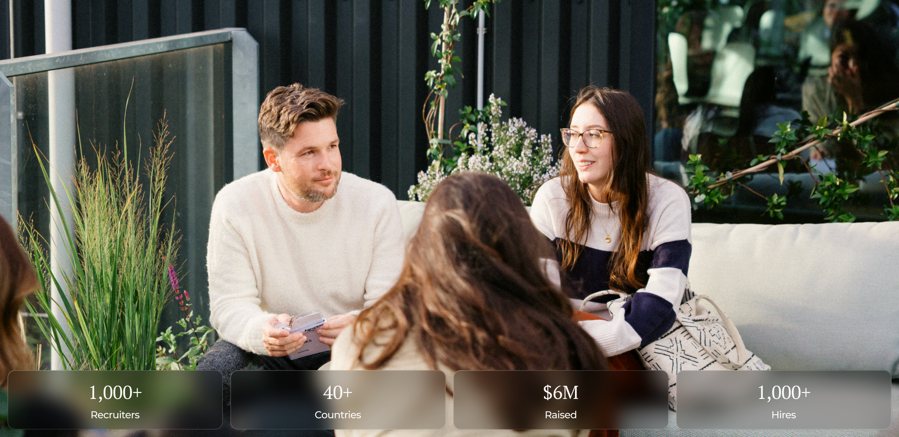 Colleagues in discussion in a bright, modern workspace