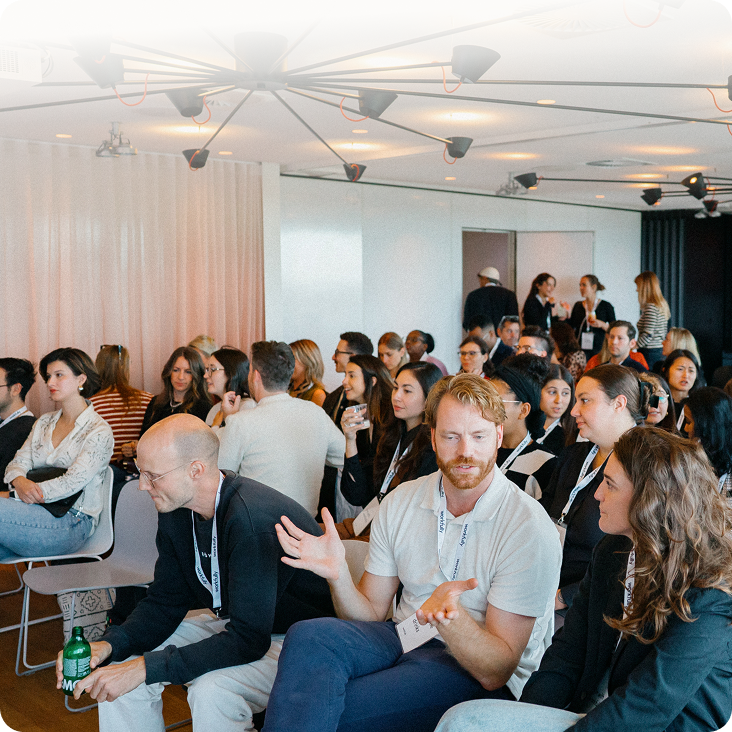 Professionals seated at a conference session in a modern venue
