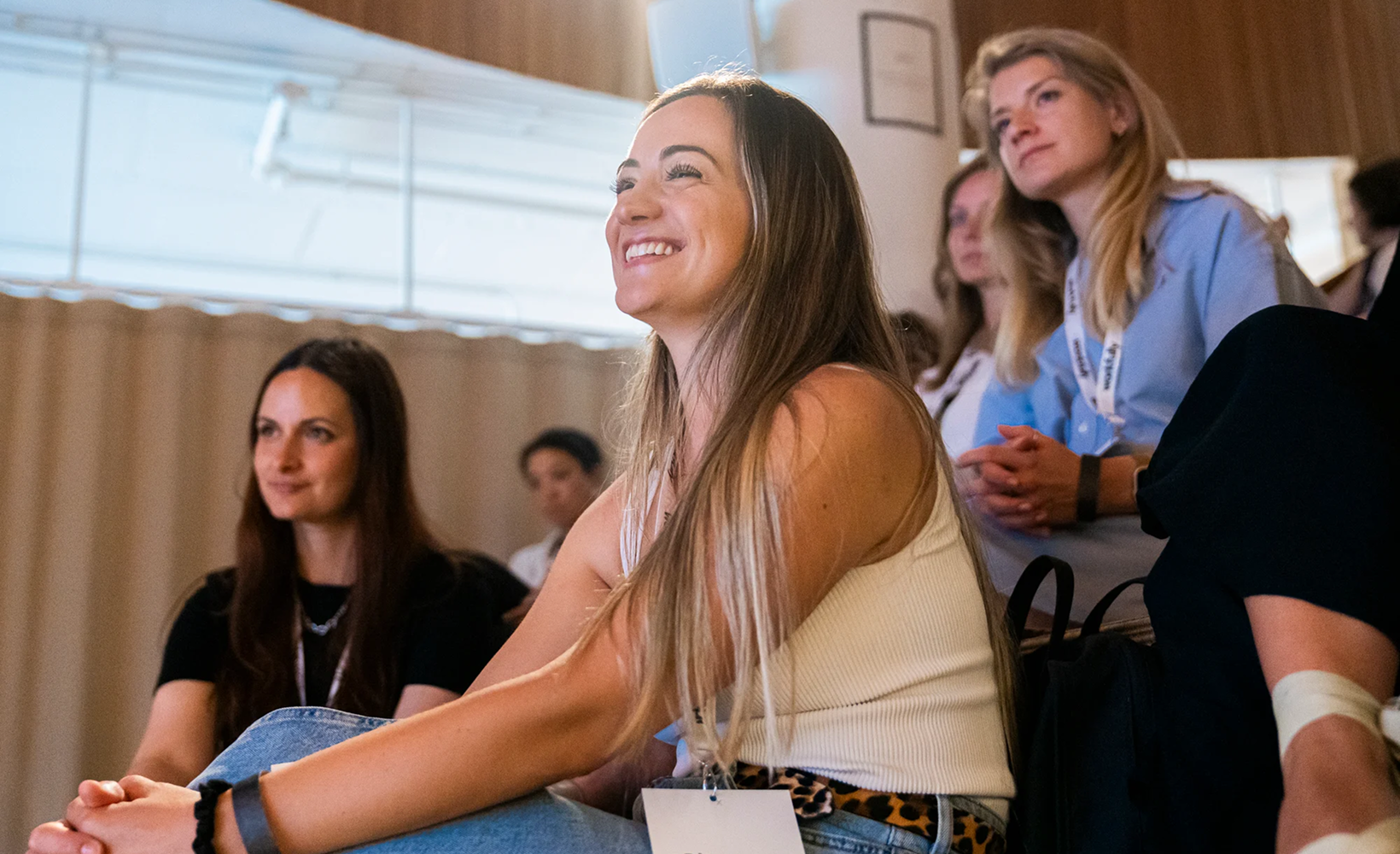 Attendees smiling during a Workfully event session