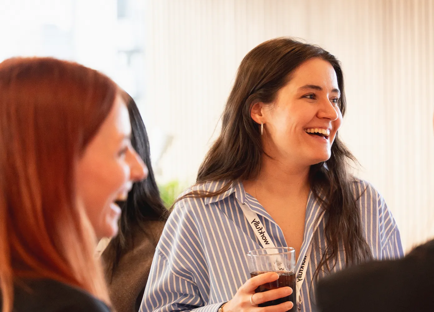 Professionals networking at a business event with conversation and refreshments